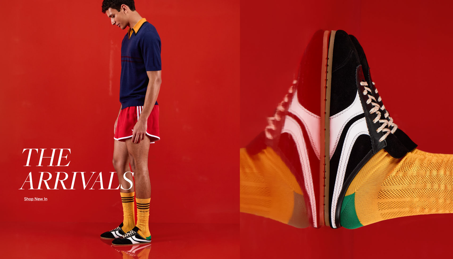 Stars, Stripes & Summer — Shop New In. Man in navy polo, red shorts, yellow socks and sneakers on red background.