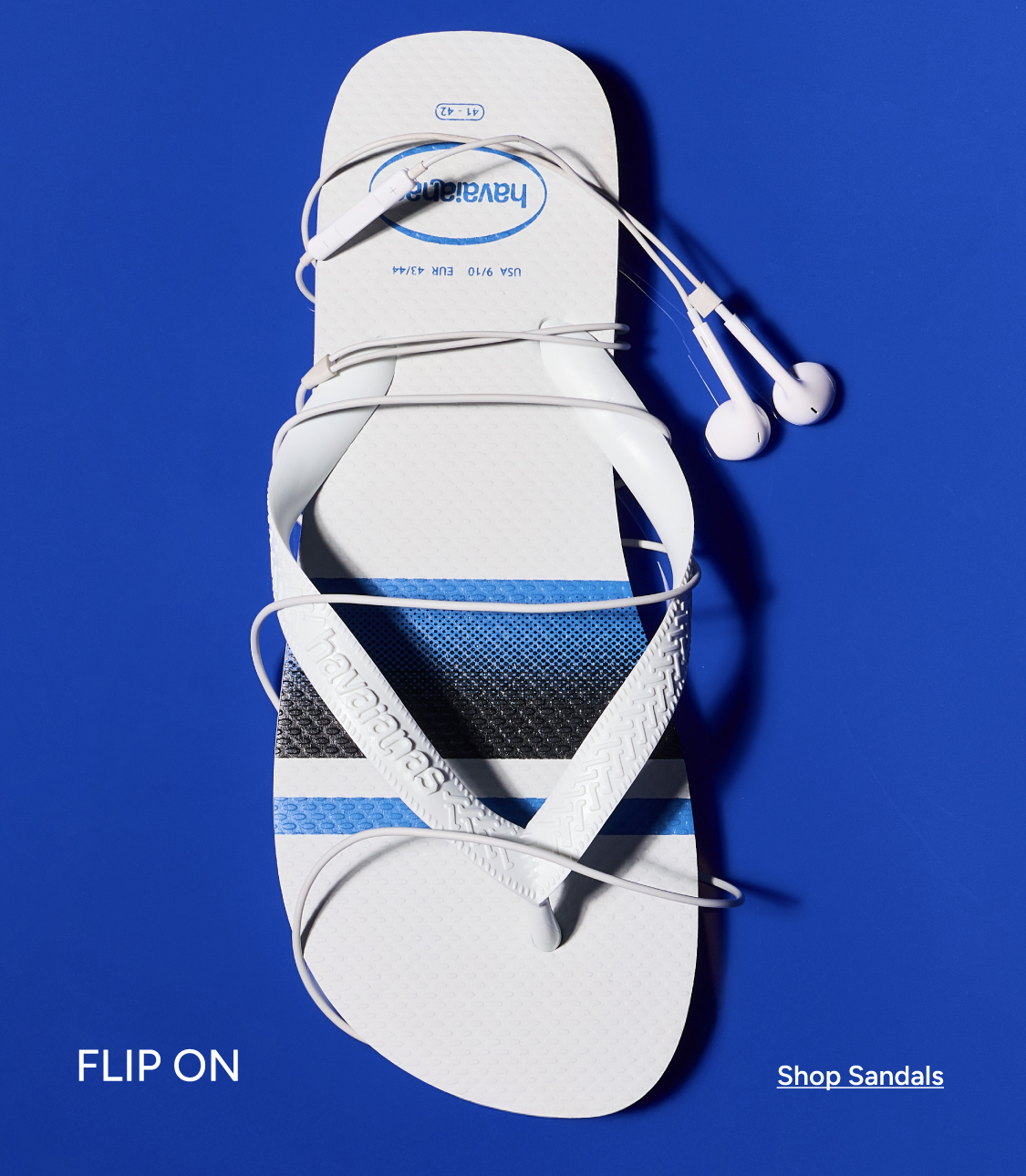 Havaianas white flip-flop with earbuds wrapped around it on blue background — Flip On. Shop Sandals