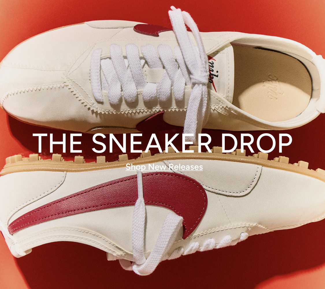 The Sneaker Drop — Shop New Releases. Nike sneakers in cream and red colorway on a red background.
