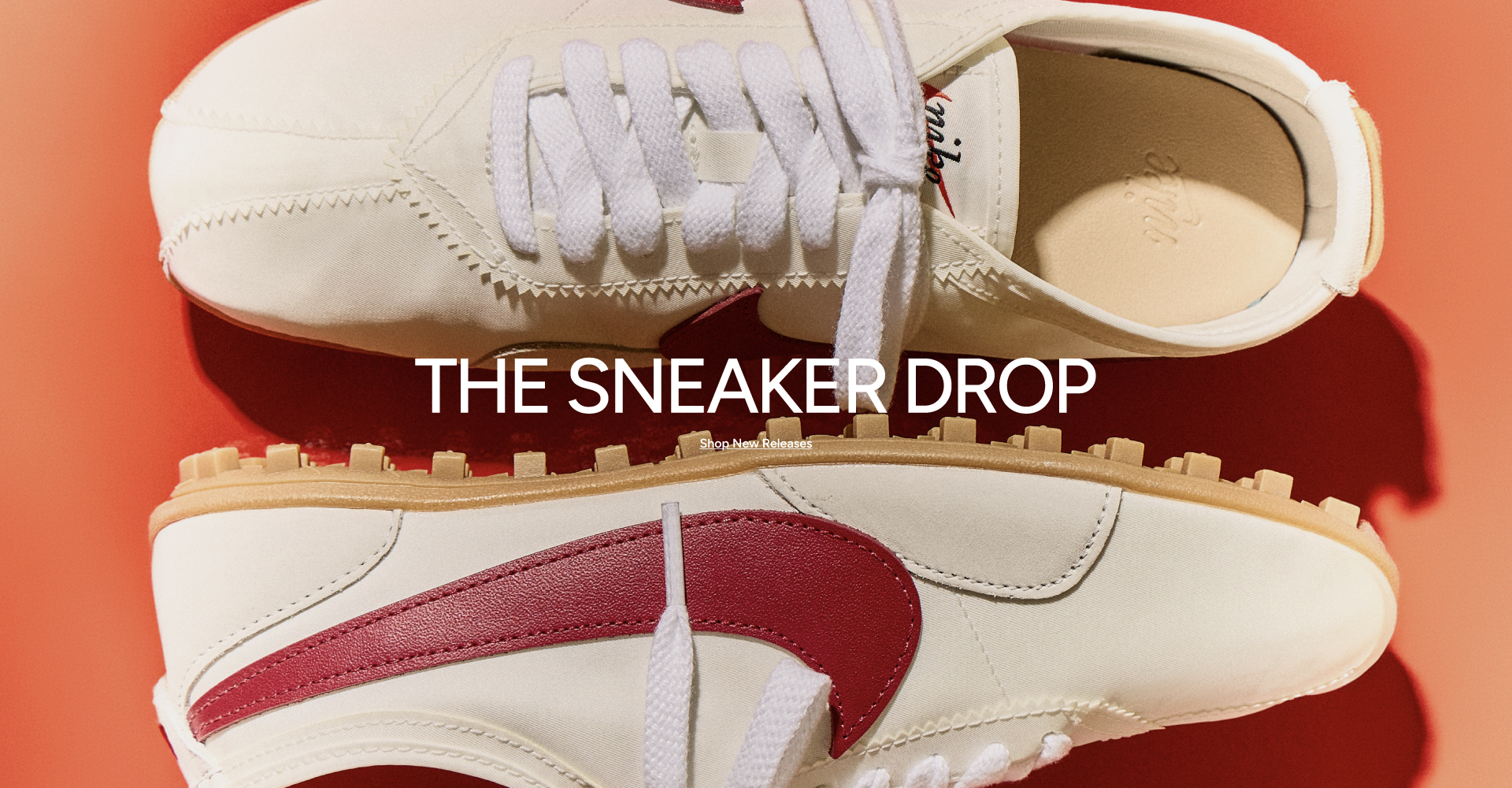 The Sneaker Drop — Shop New Releases. White and red Nike sneakers on coral background campaign banner.